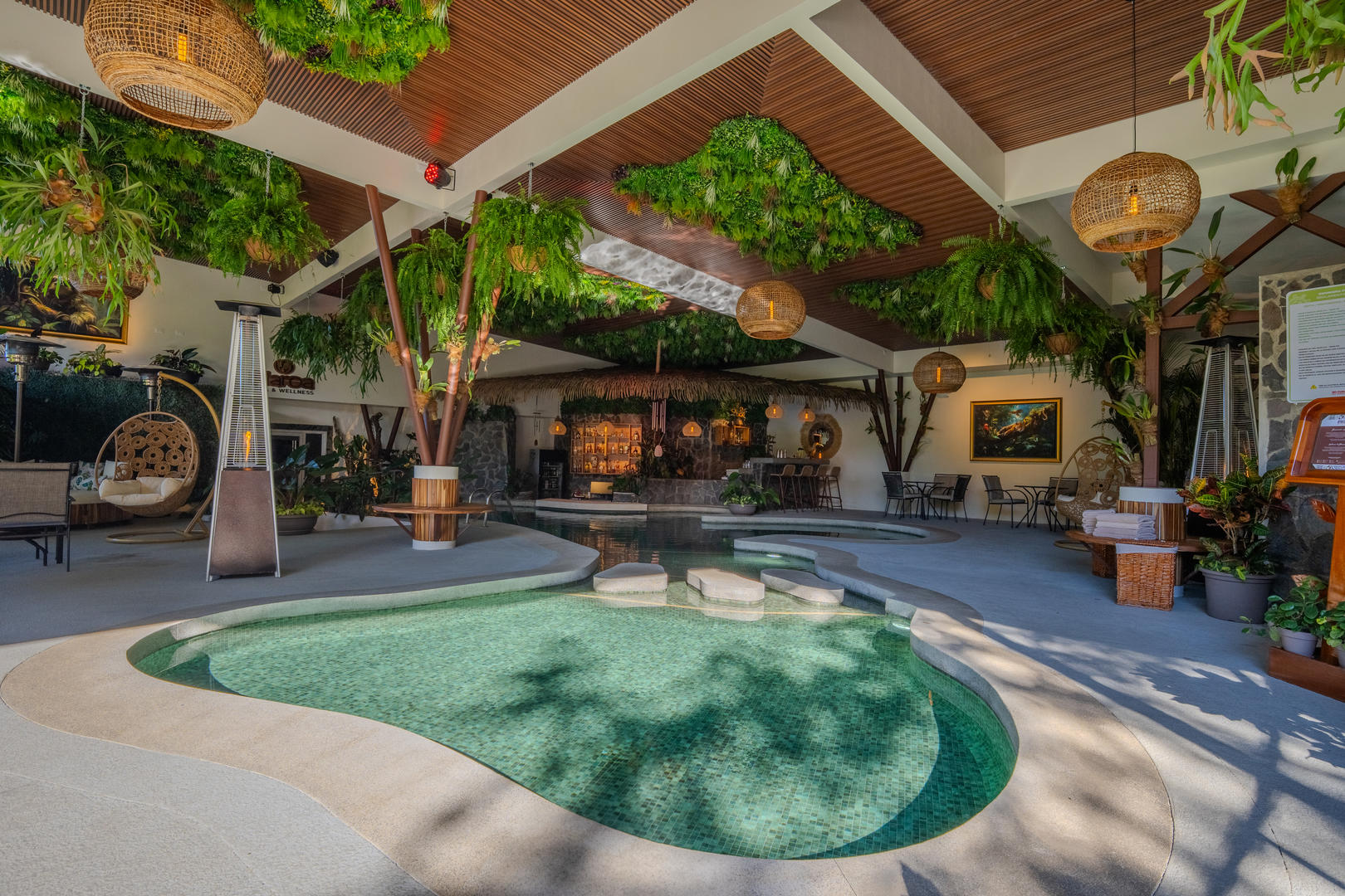 Wide view of the covered heated pool area with surrounding amenities at Hotel & Spa Poco a Poco, Monteverde