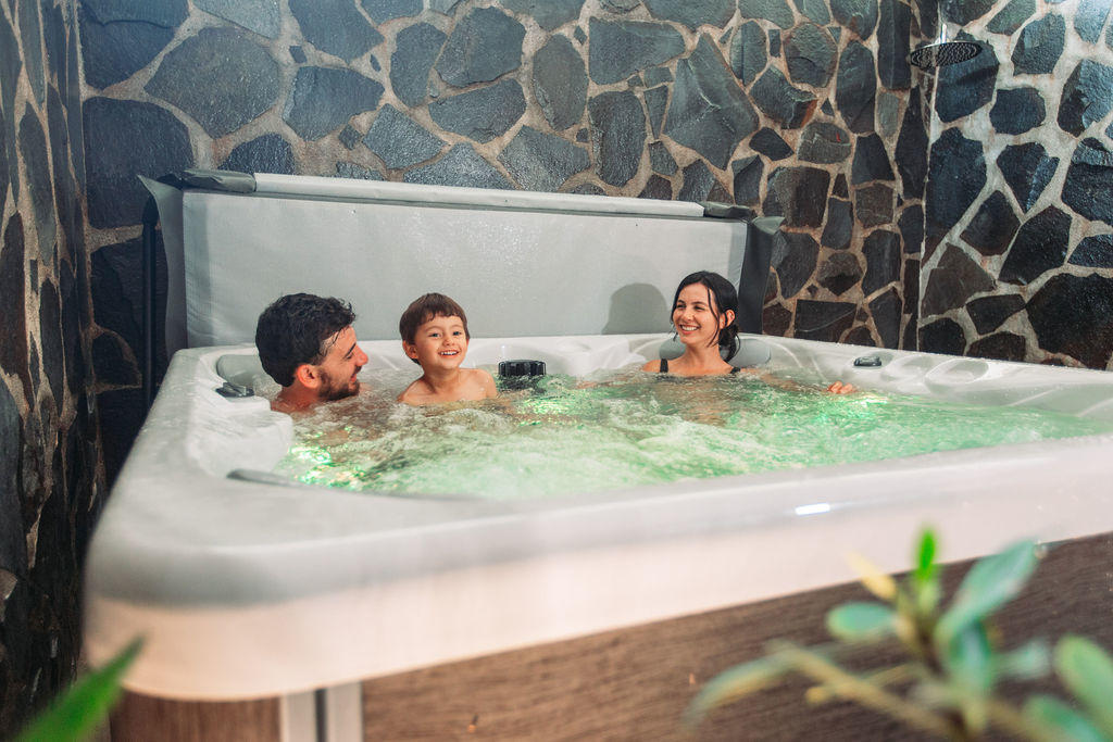 Family enjoying the jacuzzi area in Forest Deluxe with Jacuzzi at Hotel & Spa Poco a Poco, Monteverde