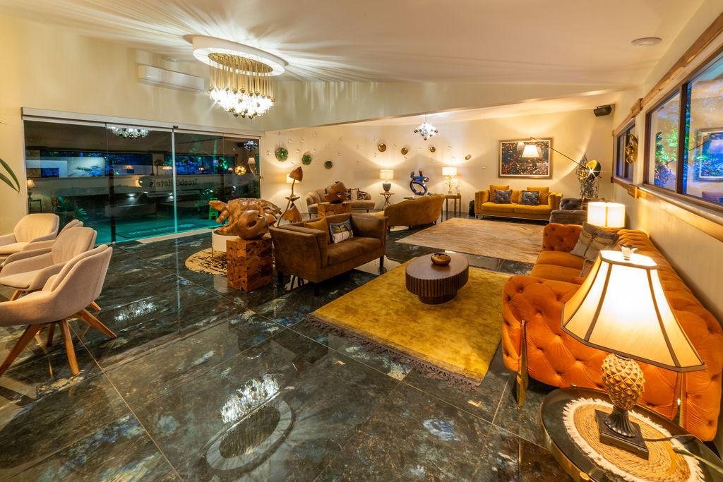 Full lobby view with multiple elegant seating spaces and stylish furniture at Hotel & Spa Poco a Poco, Monteverde