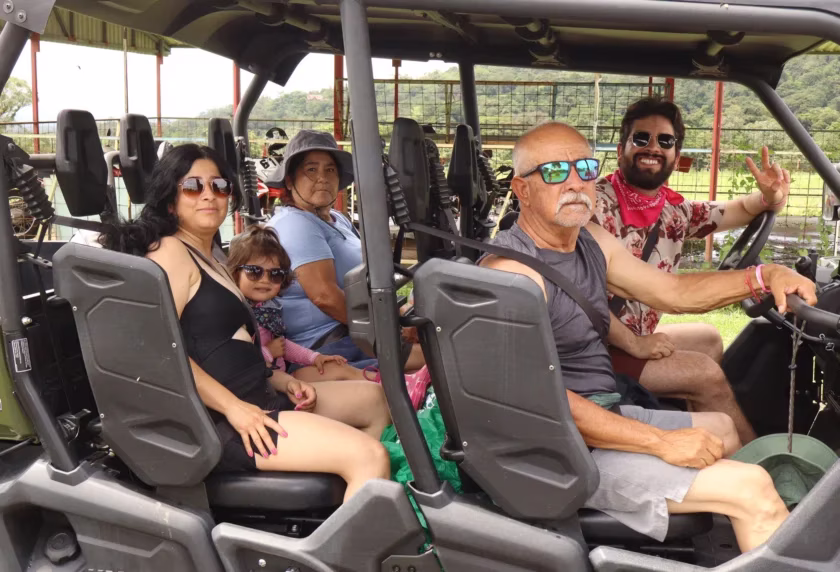 Family of five posing inside a side by side UTV before starting the tour in La Fortuna, Costa Rica