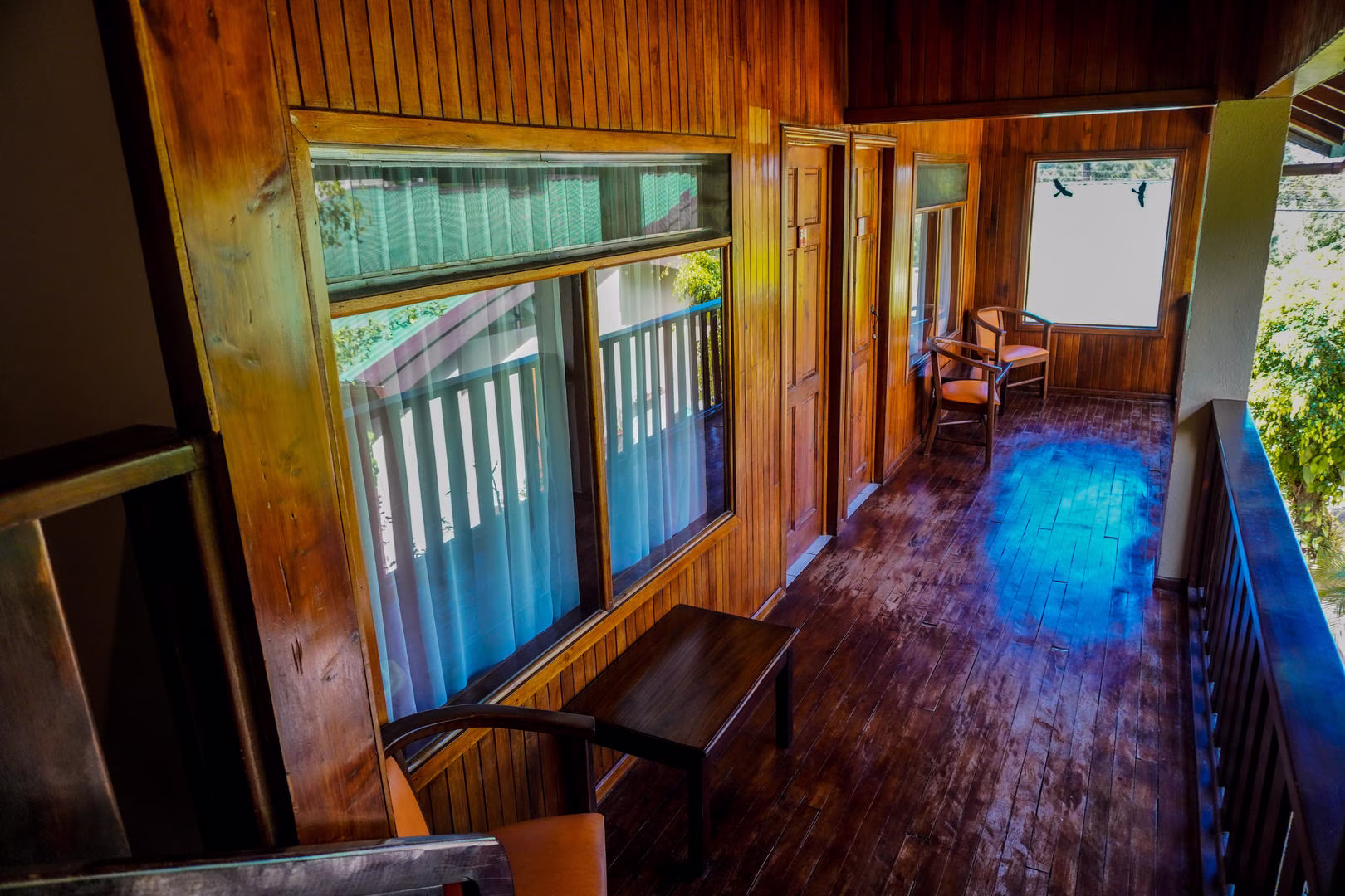 Wooden hallway leading to second floor rooms at Monteverde Country Lodge in Monteverde