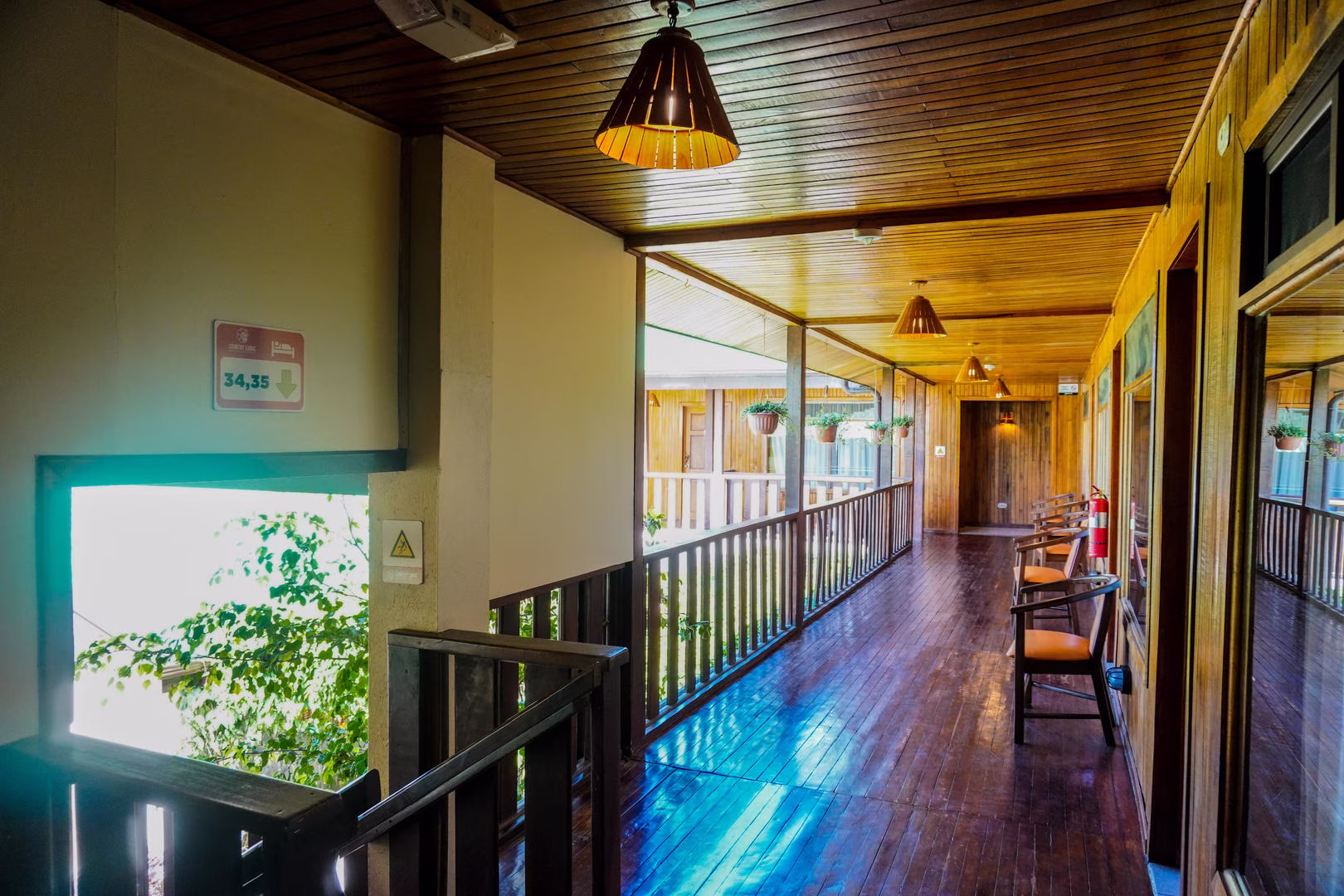 Wooden corridor toward guest rooms at Monteverde Country Lodge in Monteverde, Costa Rica