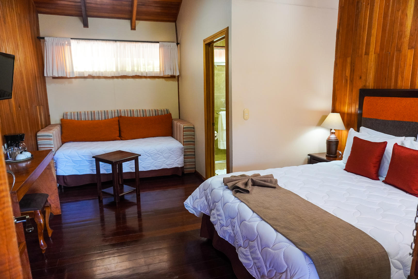 Superior room with queen bed and sofa bed, comfortable and spacious interior at Monteverde Country Lodge, Monteverde, Costa Rica