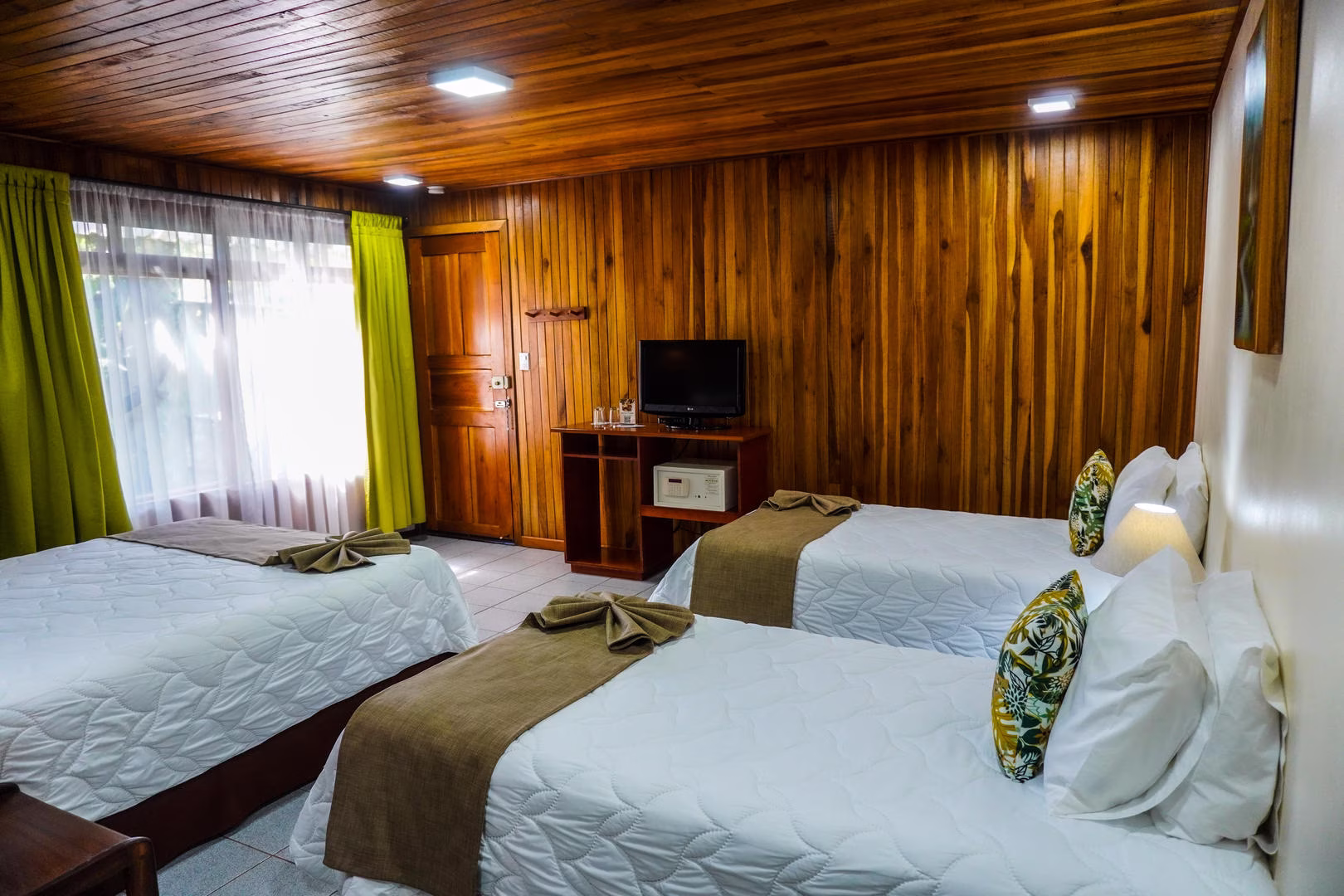 Standard room with one queen bed and two single beds at Monteverde Country Lodge in Monteverde, Costa Rica