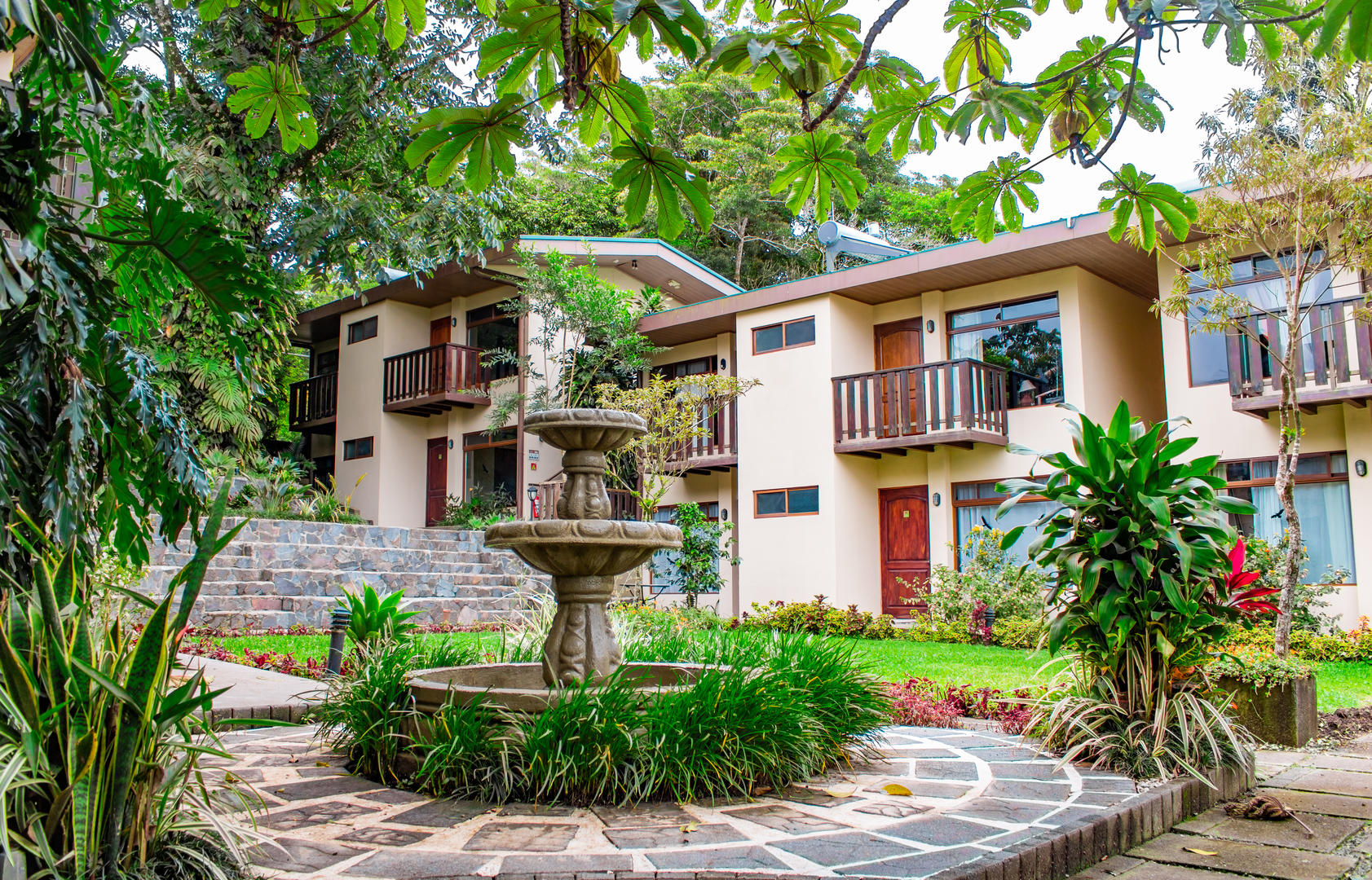 Low angle view of guest room buildings with a fountain in the foreground at Monteverde Country Lodge, Monteverde, Costa Rica