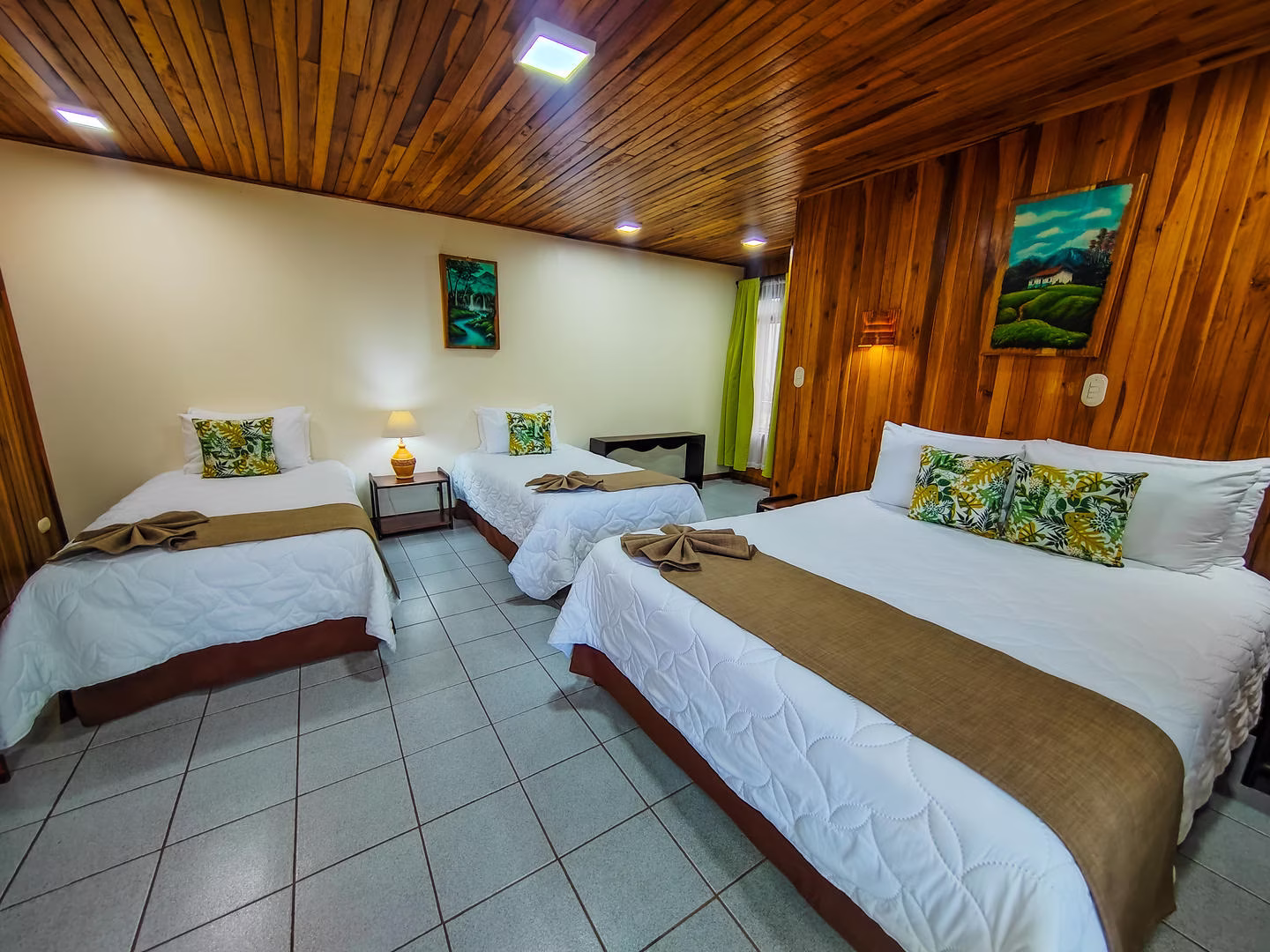 Standard room with one queen bed and two single beds at Monteverde Country Lodge, alternate view