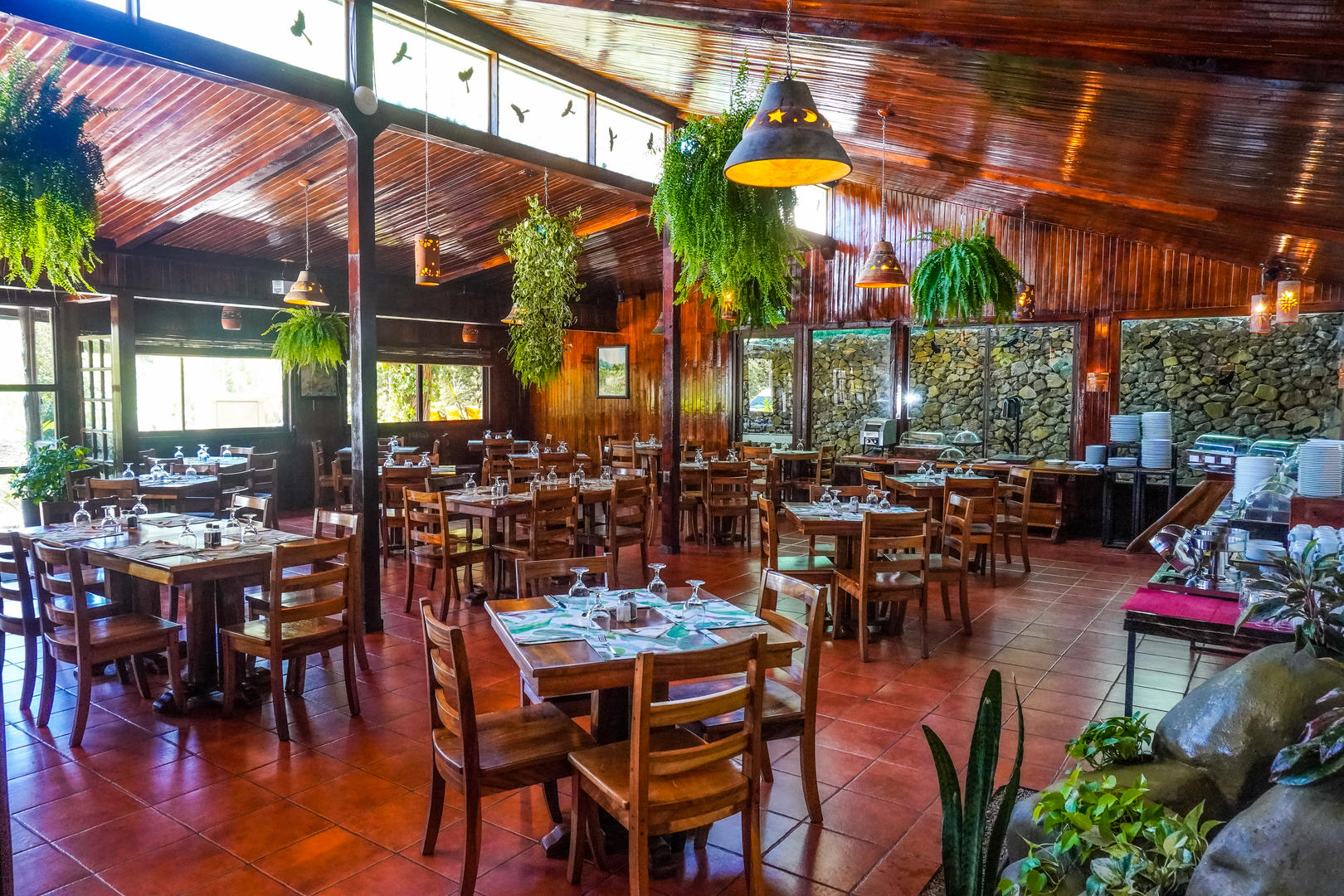 Wide view of Restaurant Fontana with multiple dining tables and open layout at Monteverde Country Lodge, Monteverde, Costa Rica