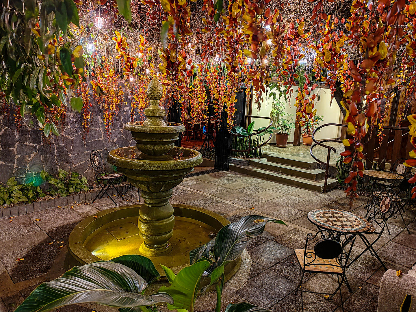 Interior courtyard fountain at night with warm lighting at Monteverde Country Lodge, Monteverde, Costa Rica