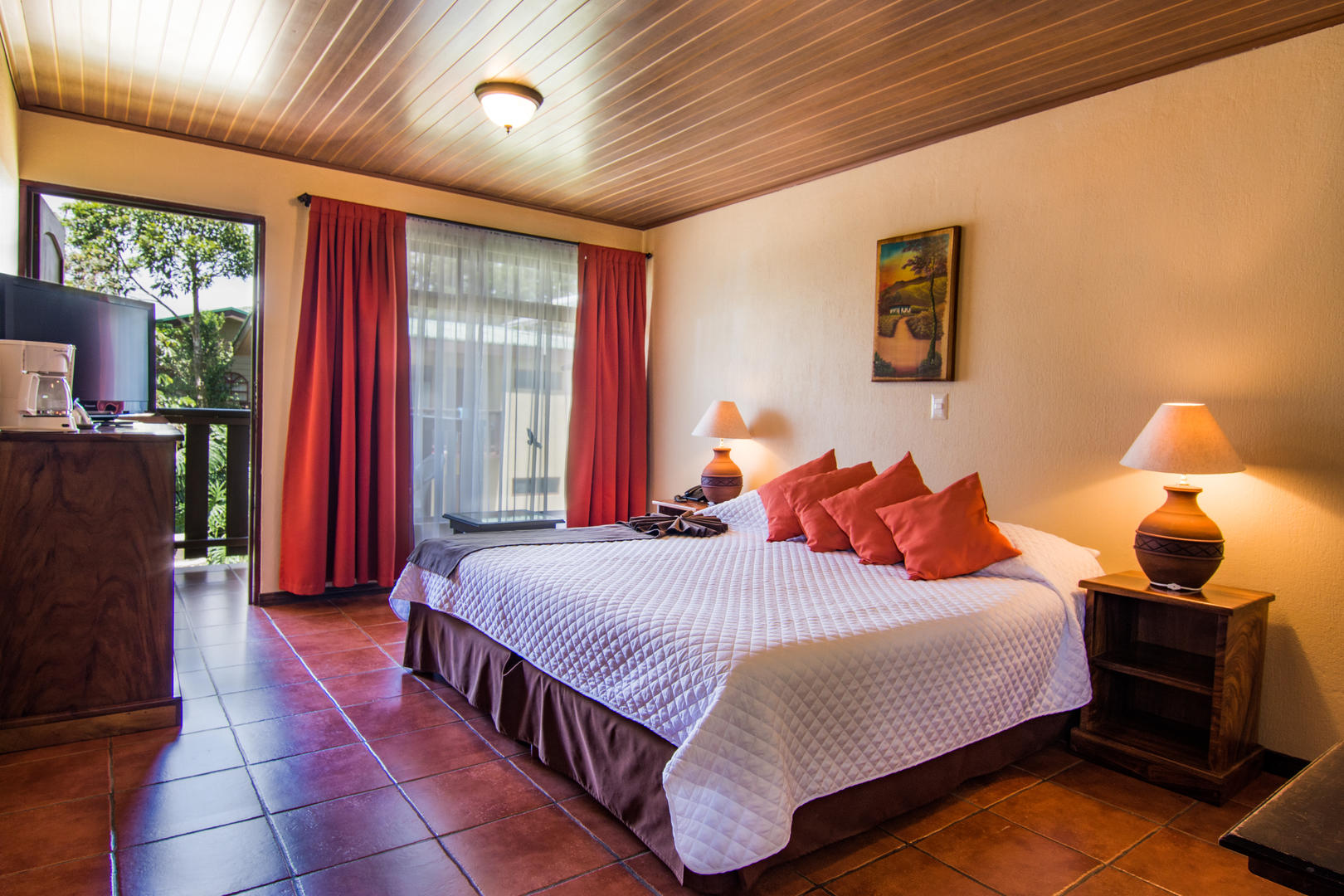 Superior room with king bed, warm wooden accents and garden views at Monteverde Country Lodge, Monteverde, Costa Rica