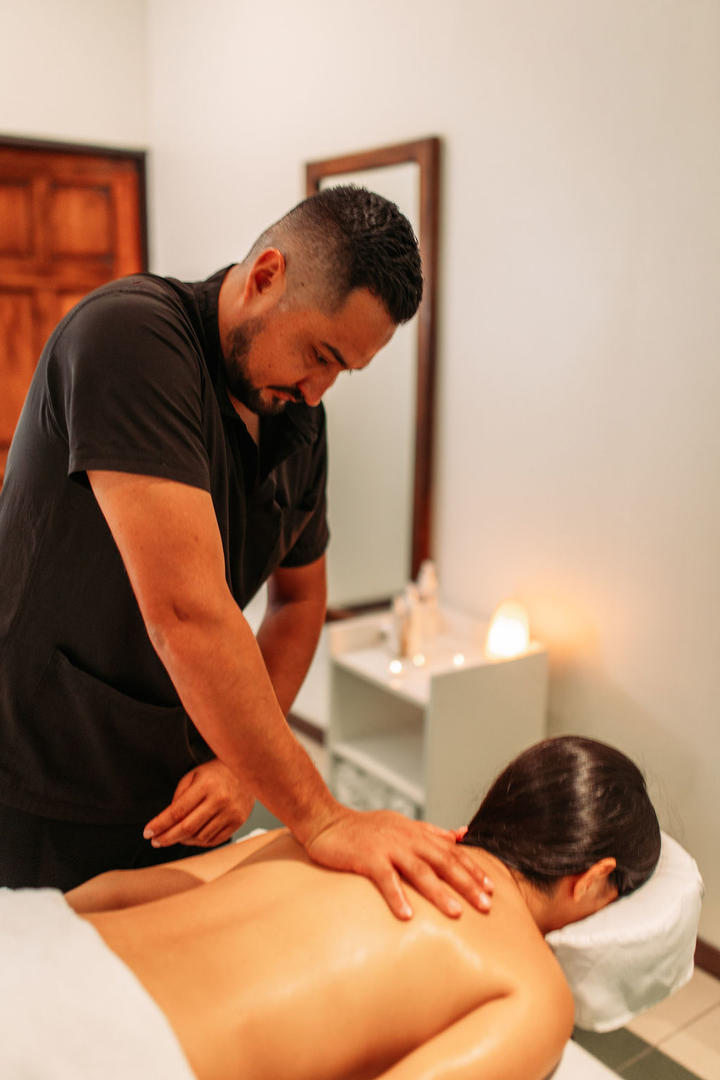 Woman receiving a professional back massage inside the spa at Naroa Spa, Monteverde Country Lodge, Monteverde, Costa Rica