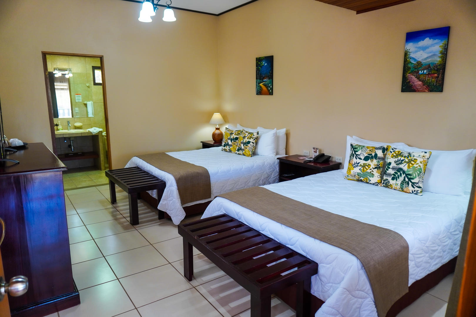 Superior room with two queen beds and visible bathroom area in the background at Monteverde Country Lodge, Monteverde, Costa Rica