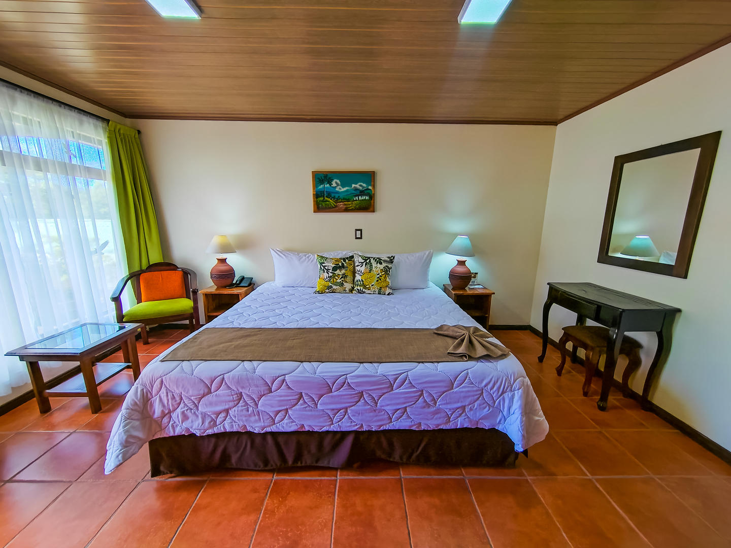 Front view of superior room with king bed, showing full layout and seating area at Monteverde Country Lodge, Monteverde, Costa Rica