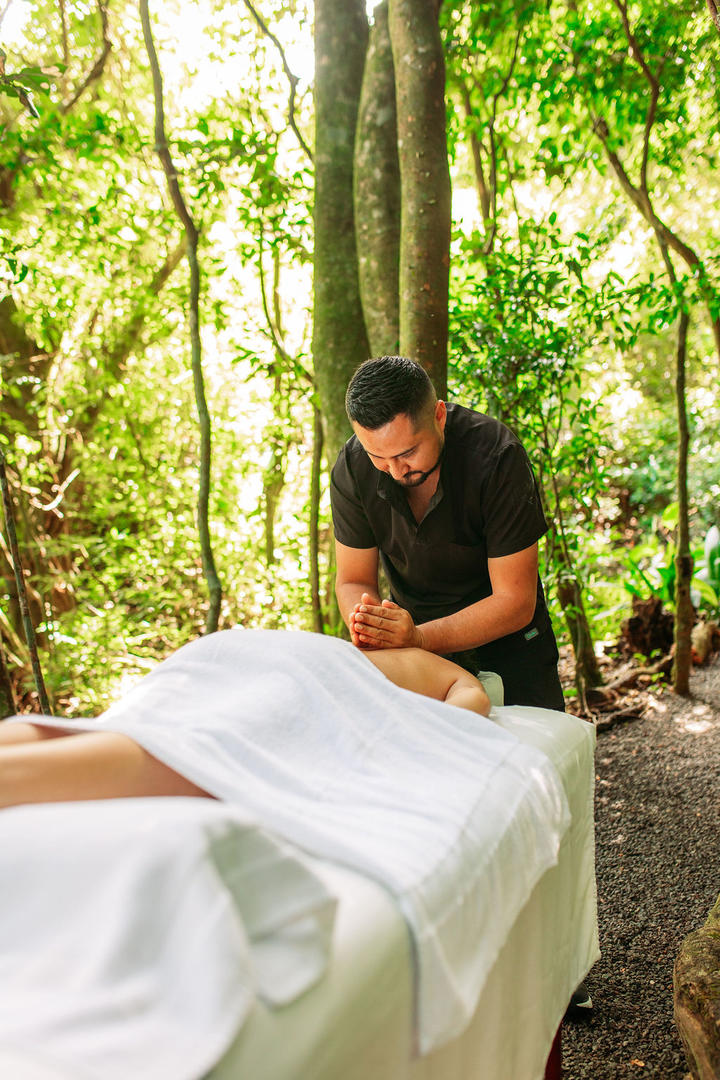 Woman receiving a professional back massage in a forest setting at Naroa Spa, Monteverde Country Lodge, Monteverde, Costa Rica