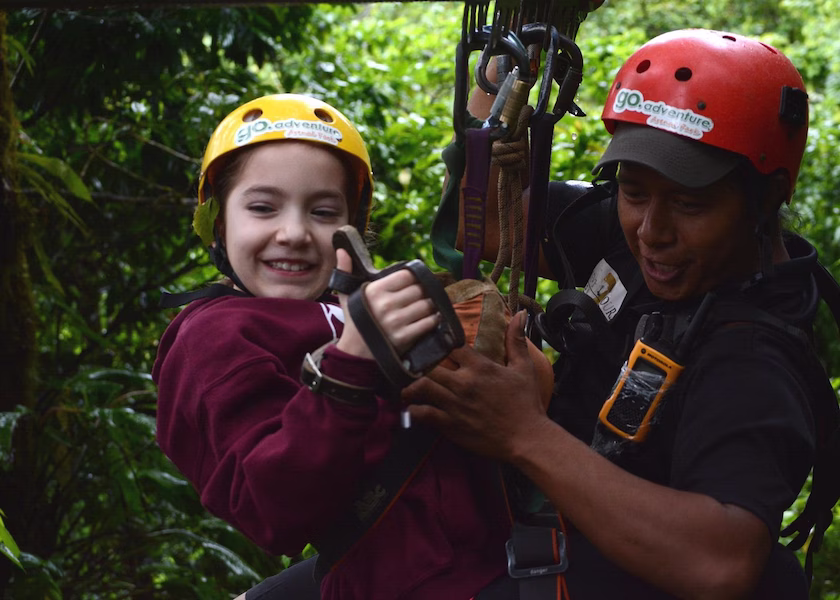 Smiling girl being assisted by a guide on the platform