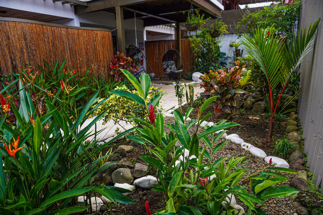 Garden view of ground level rooms surrounded by greenery at La Fortuna Lodge, La Fortuna, Costa Rica