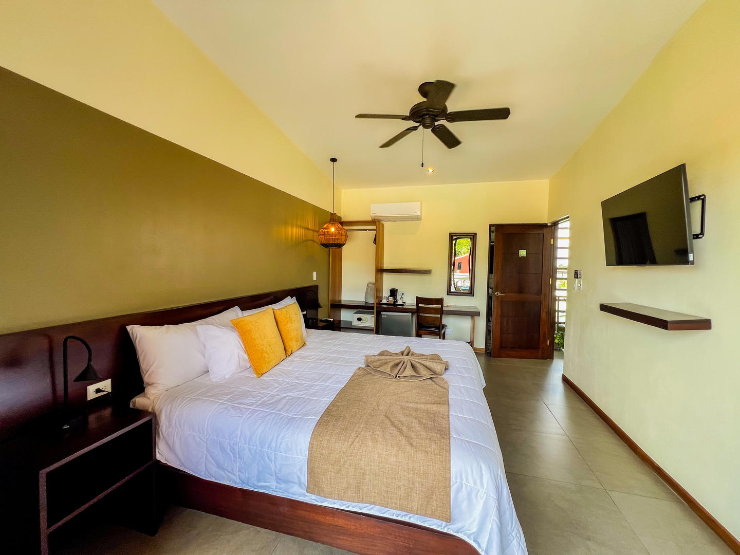 Premium room with one king bed showing amenities and bedding at La Fortuna Lodge, La Fortuna, Costa Rica