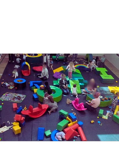 Children and babies playing with the toys and baby gym in the hall