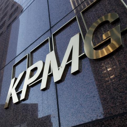 Close up view of KPMG building with company name in gold.