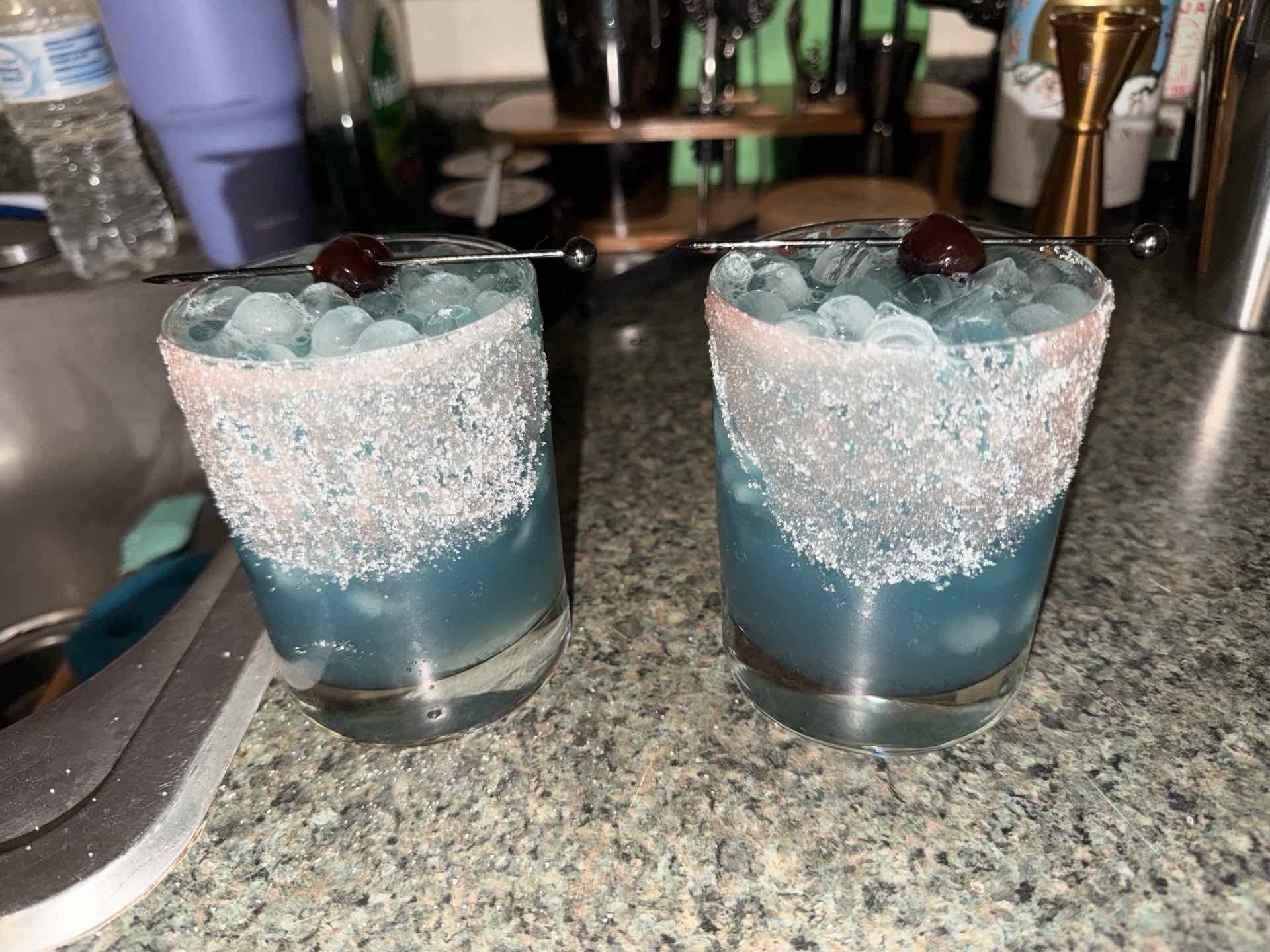 Community photo of a Purple Rain cocktail: Used indigo gin instead of vodka and rimmed with sugar. Delicious