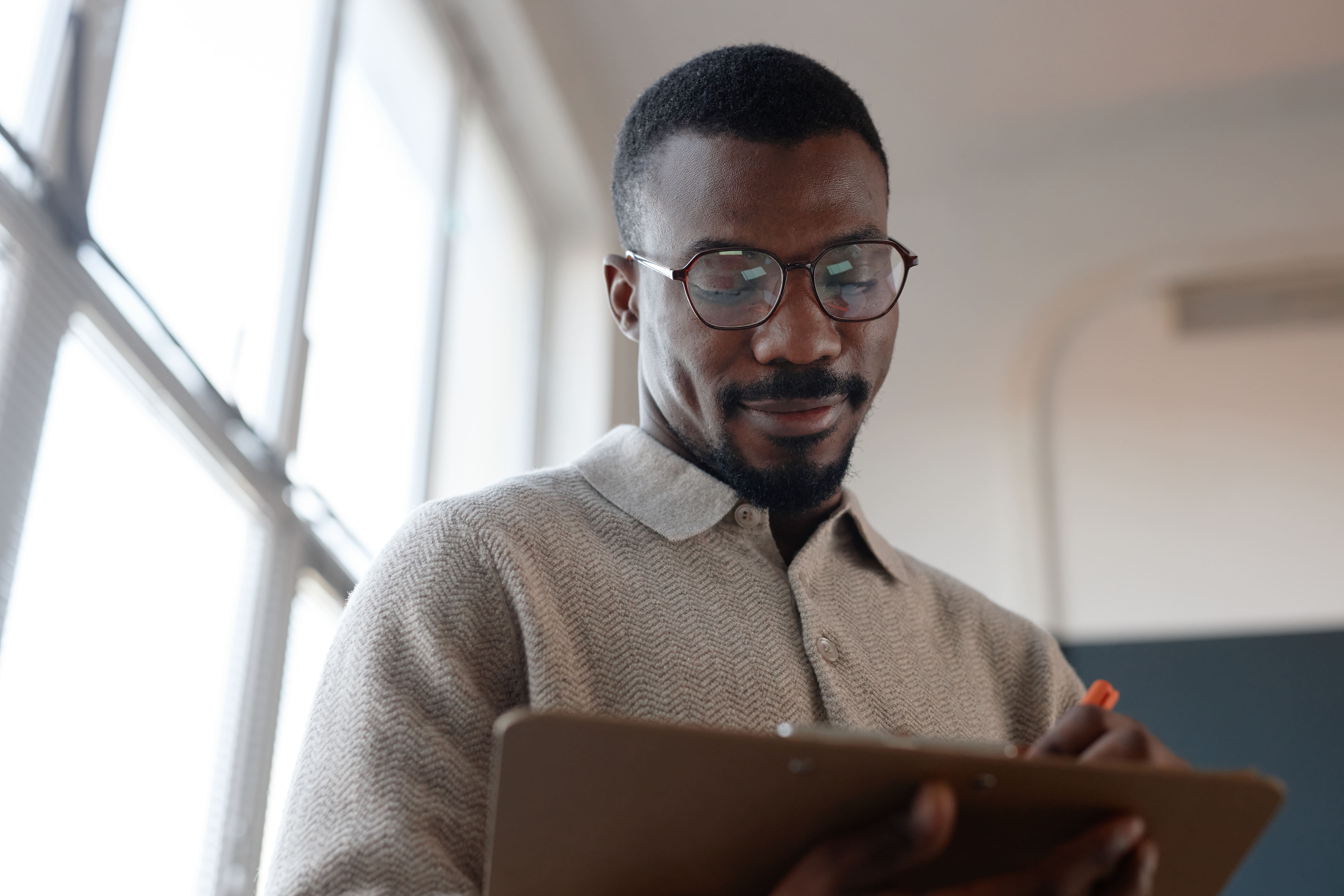 man-working-with-clipboard-near-window-light-2026-03-19-09-17-35-utc man-working-with-clipboard-near-window-light-2026-03-19-09-17-35-utc