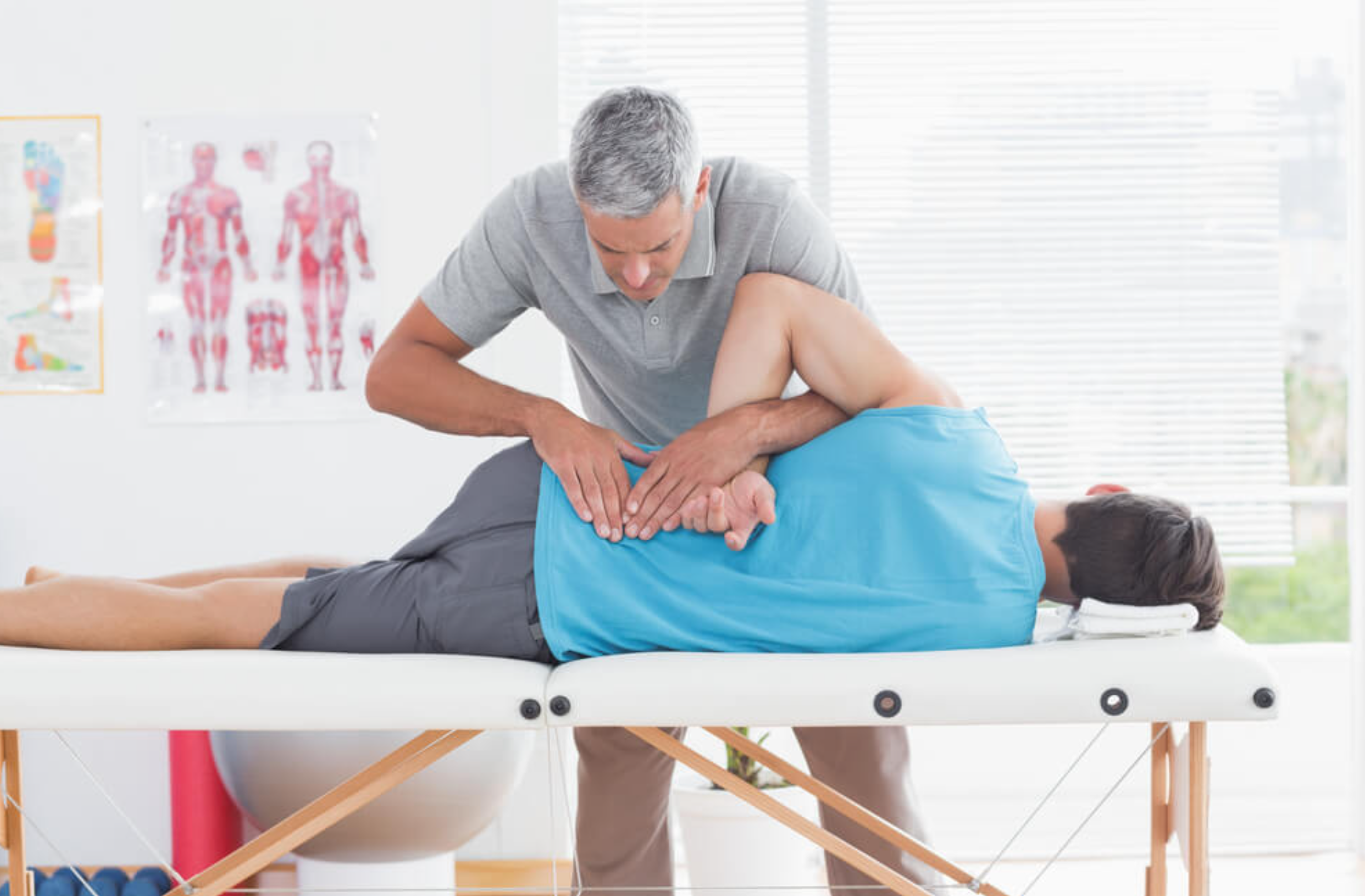 Physiotherapist helping a patient with lower back pain in Brampton