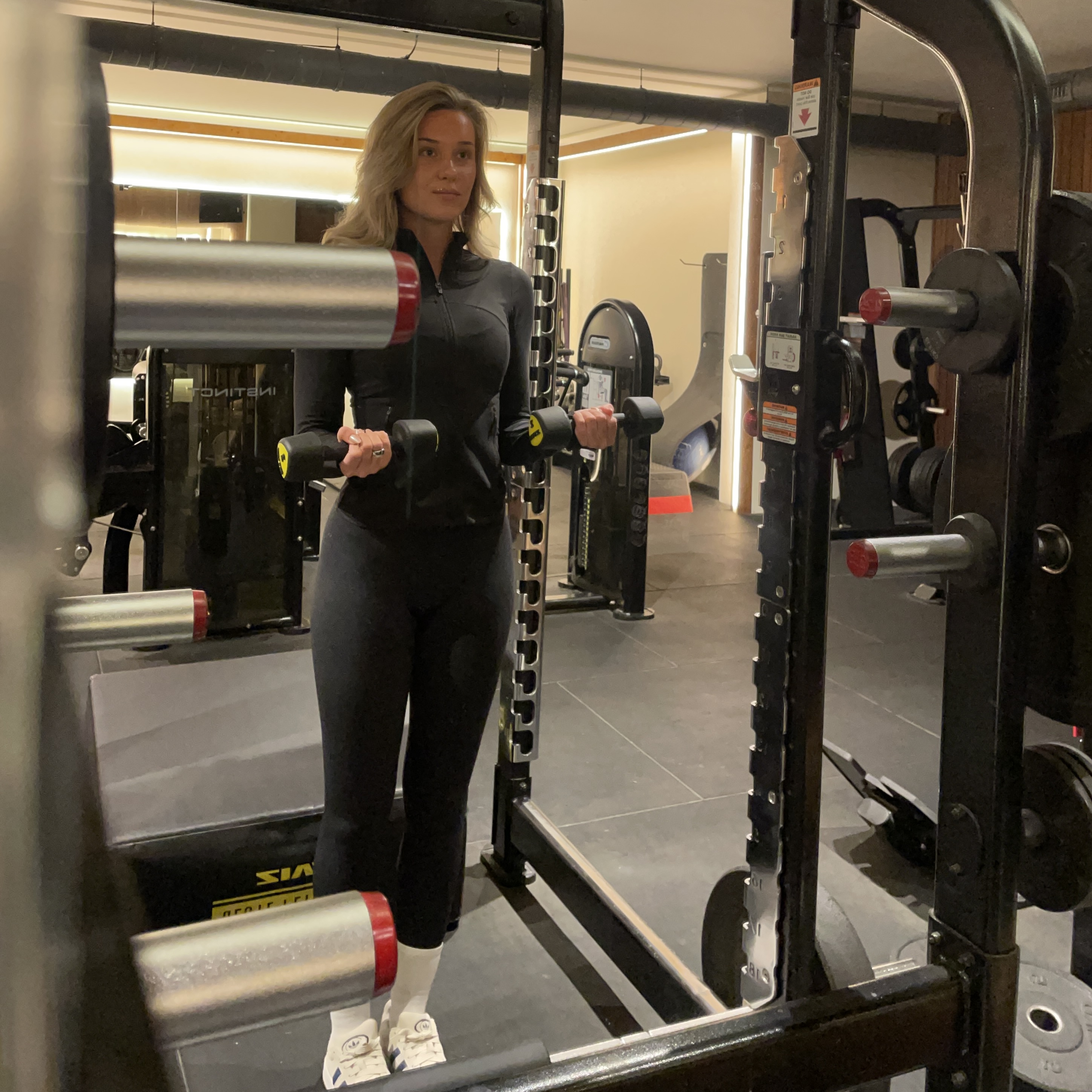 Vrouw traint intensief op een Ski-erg machine tijdens een Hyrox evenement in Nederland