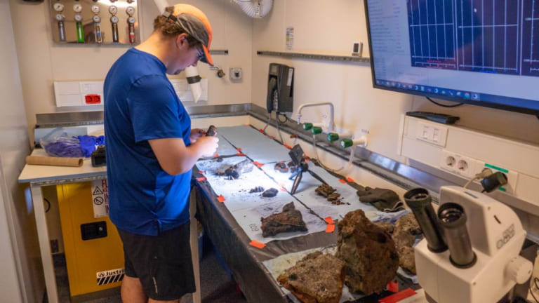 Memorial University master of science student Charles Lapointe processes rock samples.