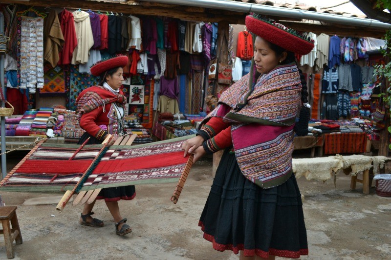 Woman wearing a red and black long-sleeved dress with a red and black hat