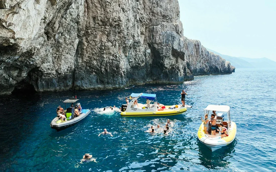 From Vlore: Unknown Escape Party Boat Cruise with Drinks, Music & Secret Swim Stops Image 1