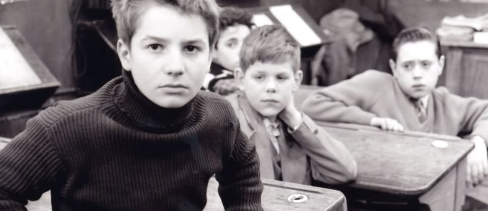 May be a black-and-white image of child and studying