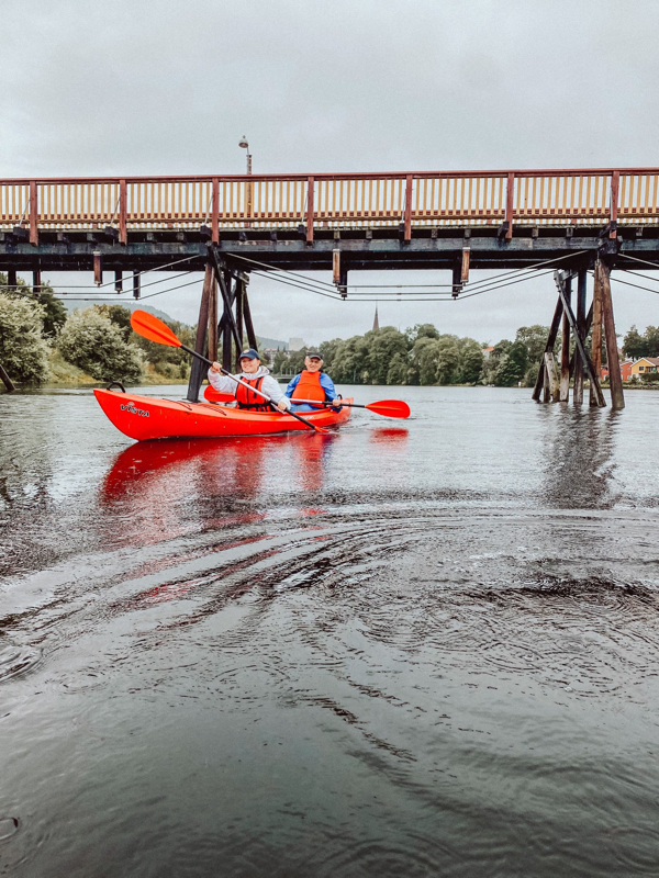 May be an image of 2 people, kayak, canoe and bridge