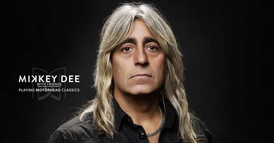 May be an image of one or more people, blonde hair, guitar and text that says 'ΜΙΧΚΥ DEE ИTΗ MIXKEYDEE RIENDS PLAYINGMOTÖRHEADCLASSIC PLAYING MOTÖRHEAD CLASSICS'