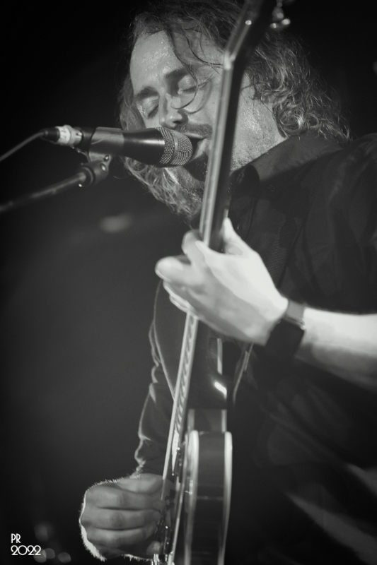 May be a black-and-white image of 1 person and guitar
