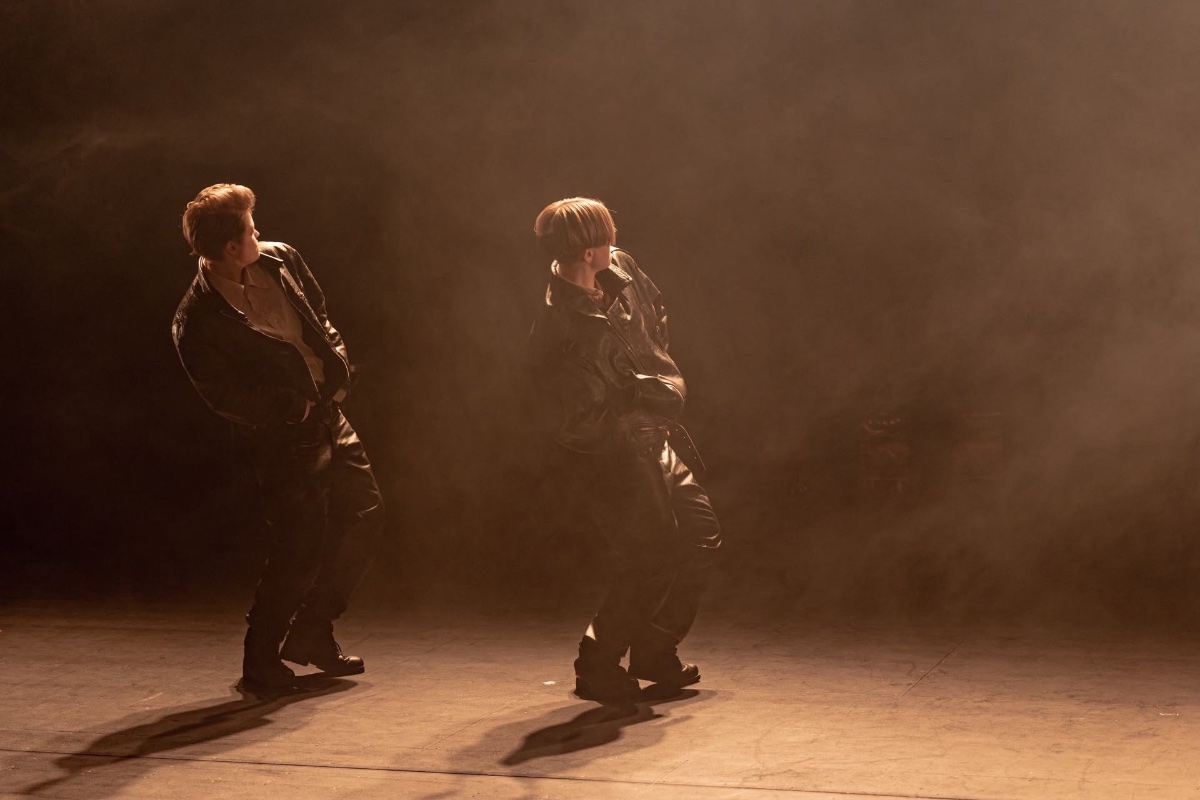 An image of two people dancing next to each other on stage