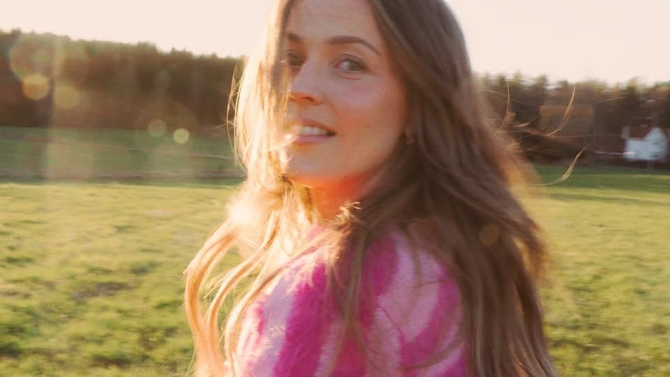 May be an image of smiling and grass