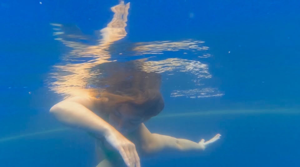 May be an image of person dancing in the swimming and pool