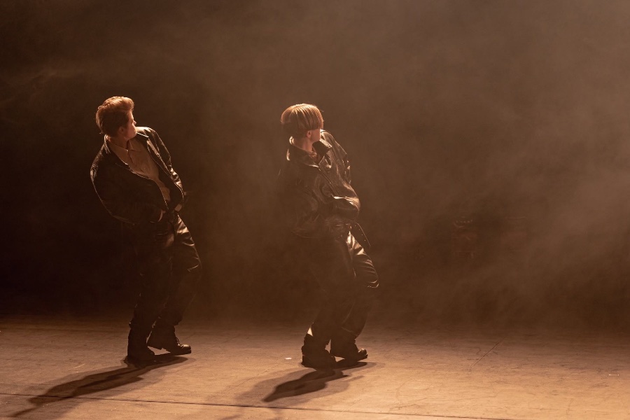 An image of two people dancing next to each other on stage