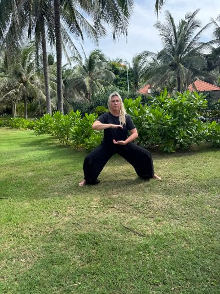 May be an image of martial arts, grass and tree