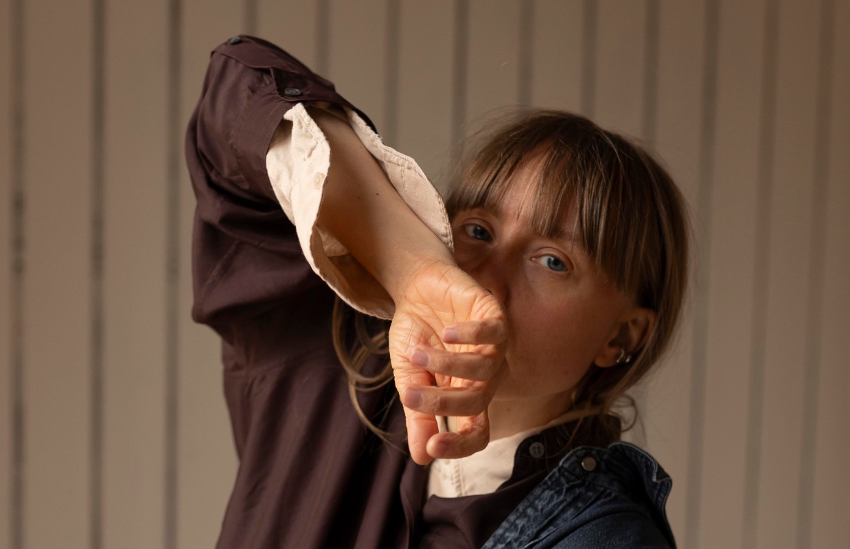 A person posing and looking in the camera