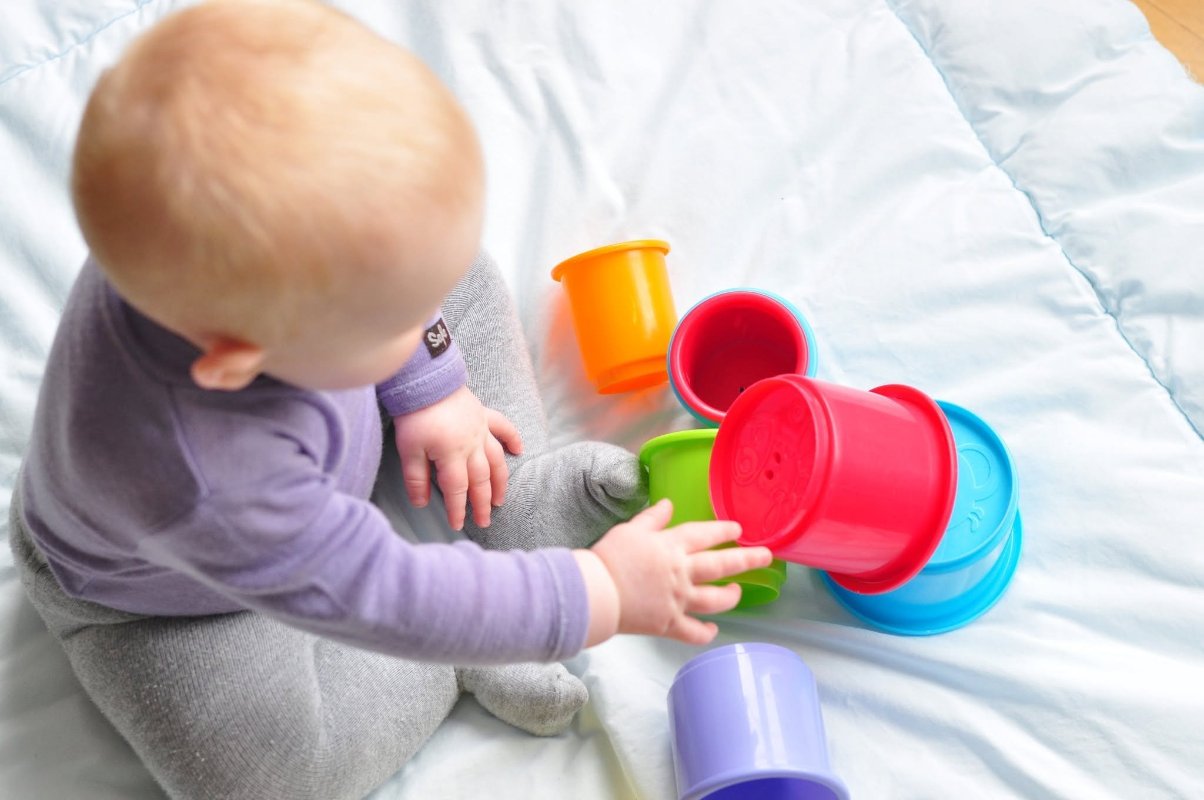 May be an image of baby, toy and text