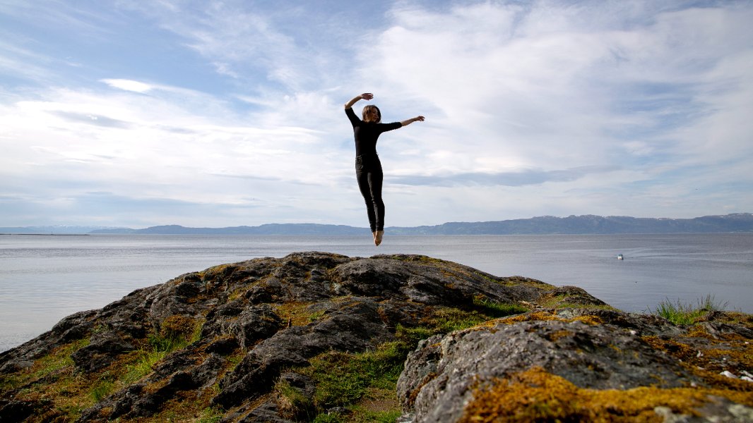  A woman jumping on a rock