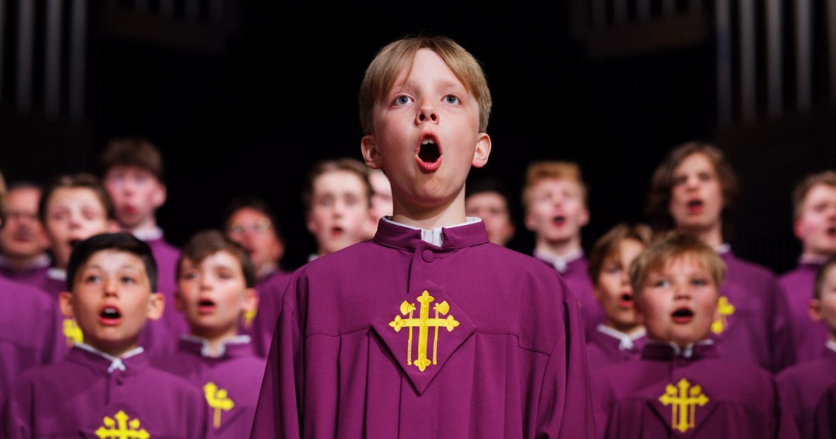 Boy in front of other boys, singing