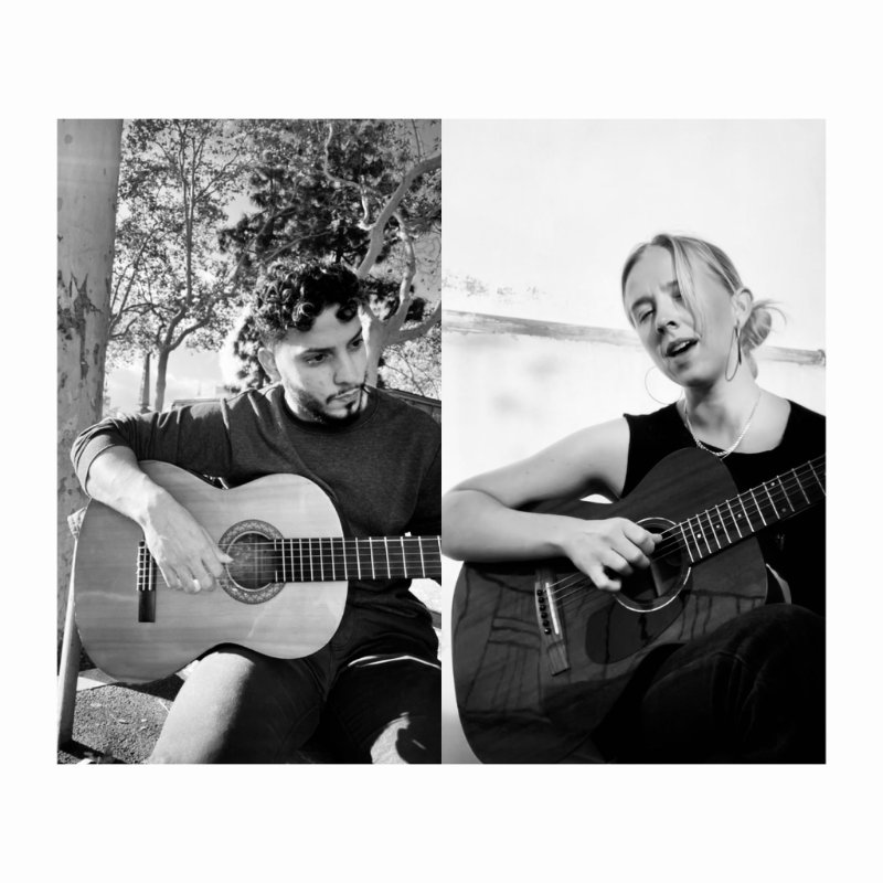 May be a black-and-white image of one or more people and guitar