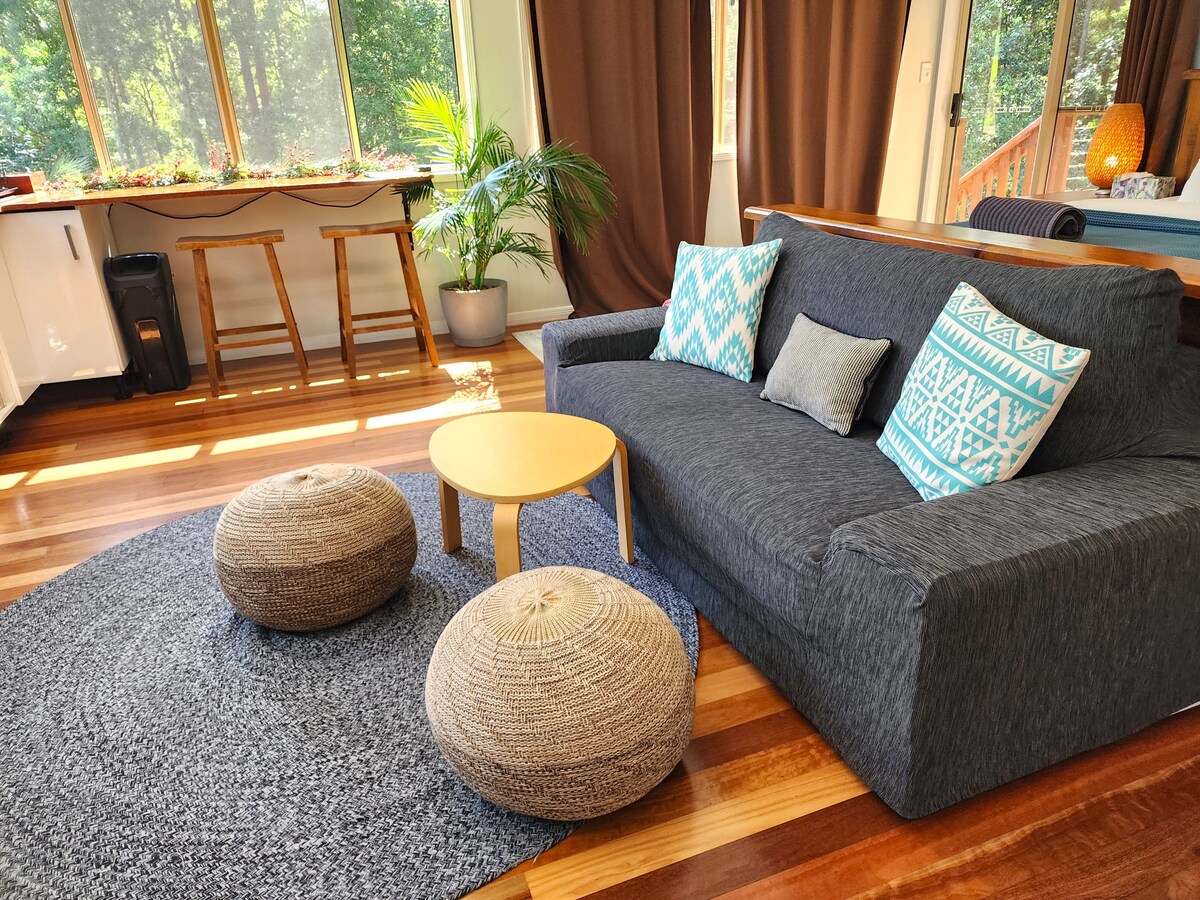 A warm, light-filled space with comfy seating and calm vibes —  ideal for putting your feet up and staying a little longer than planned!