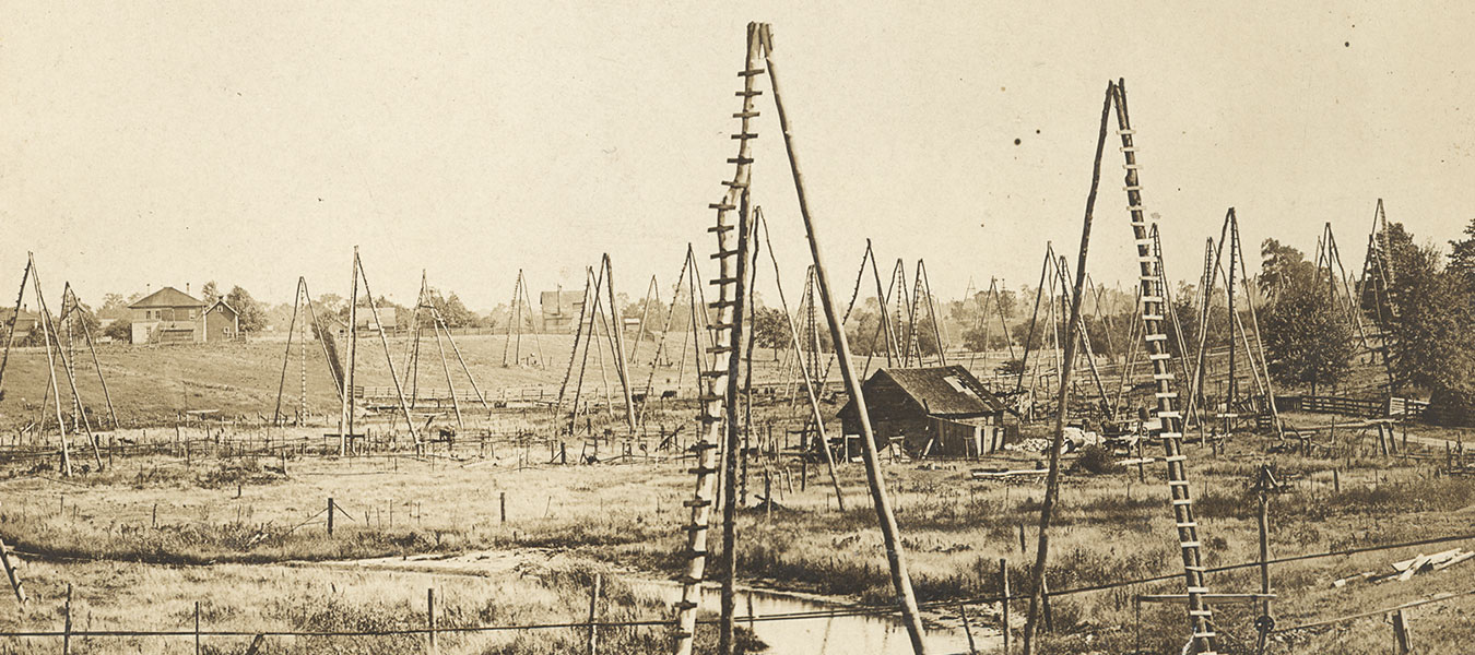 Photo of Oil Springs and three pole wells, 1858. Oil Museum, Lambton County Library.