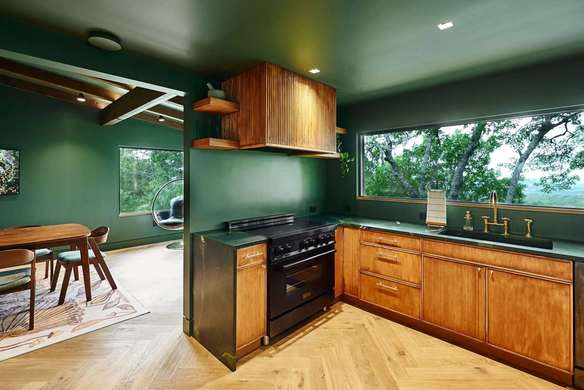 Hill Country Modern kitchen with white oak cabinets and green walls in Austin.
