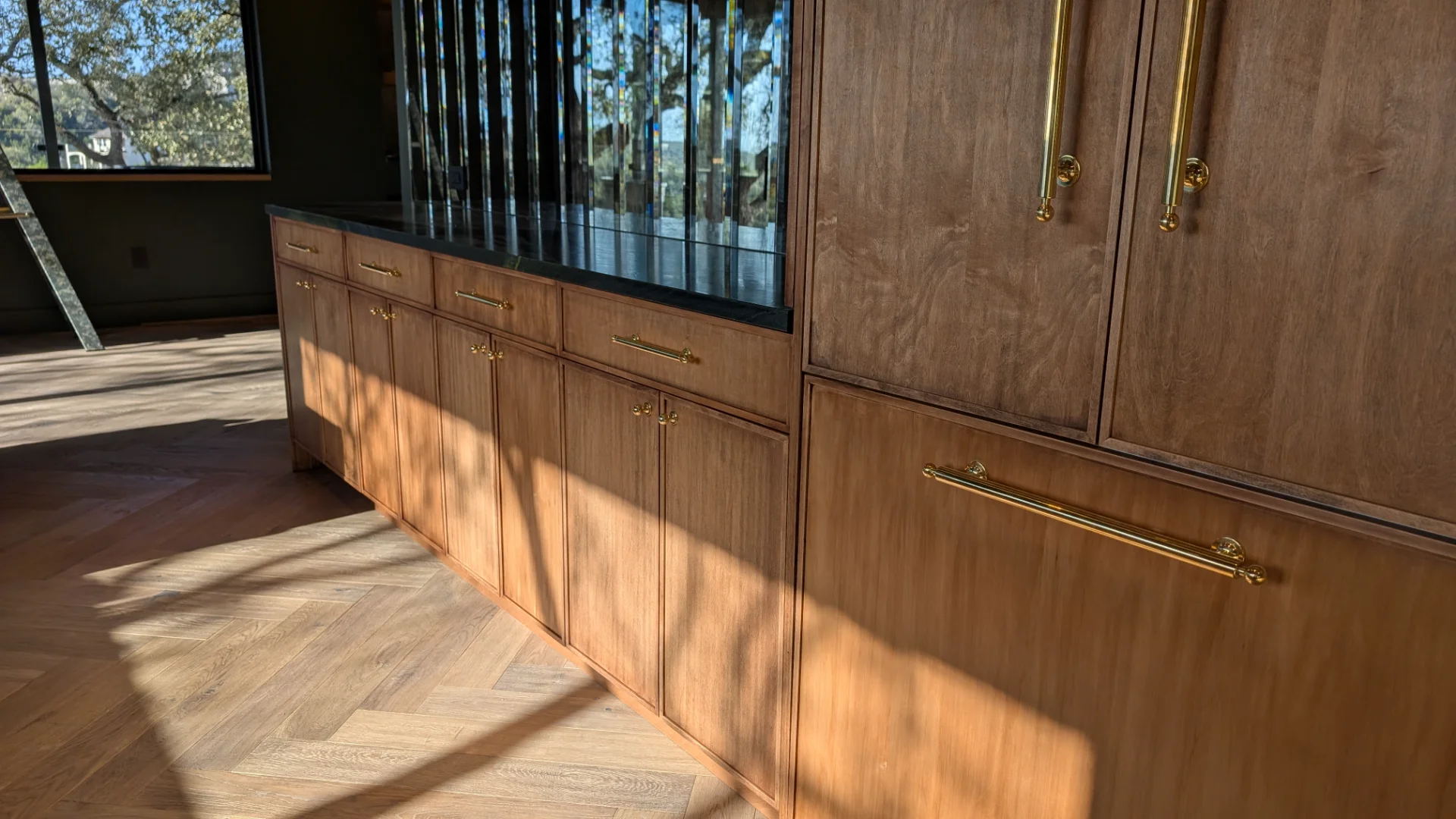 Custom fluted wood cabinetry with brass hardware in a luxury West Lake Hills Austin residence. - Detail 4