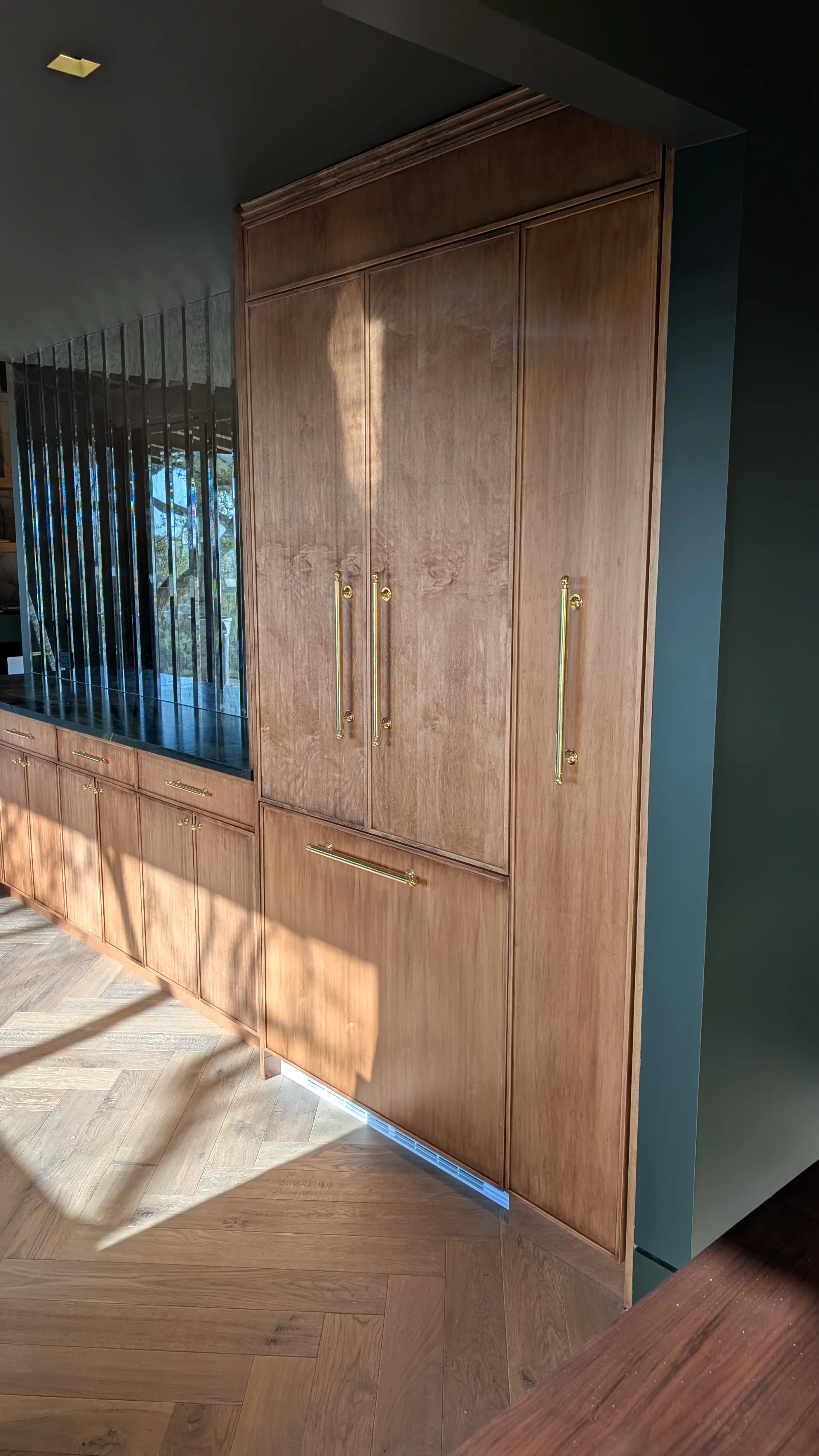 Custom fluted wood cabinetry with brass hardware in a luxury West Lake Hills Austin residence. - Detail 3