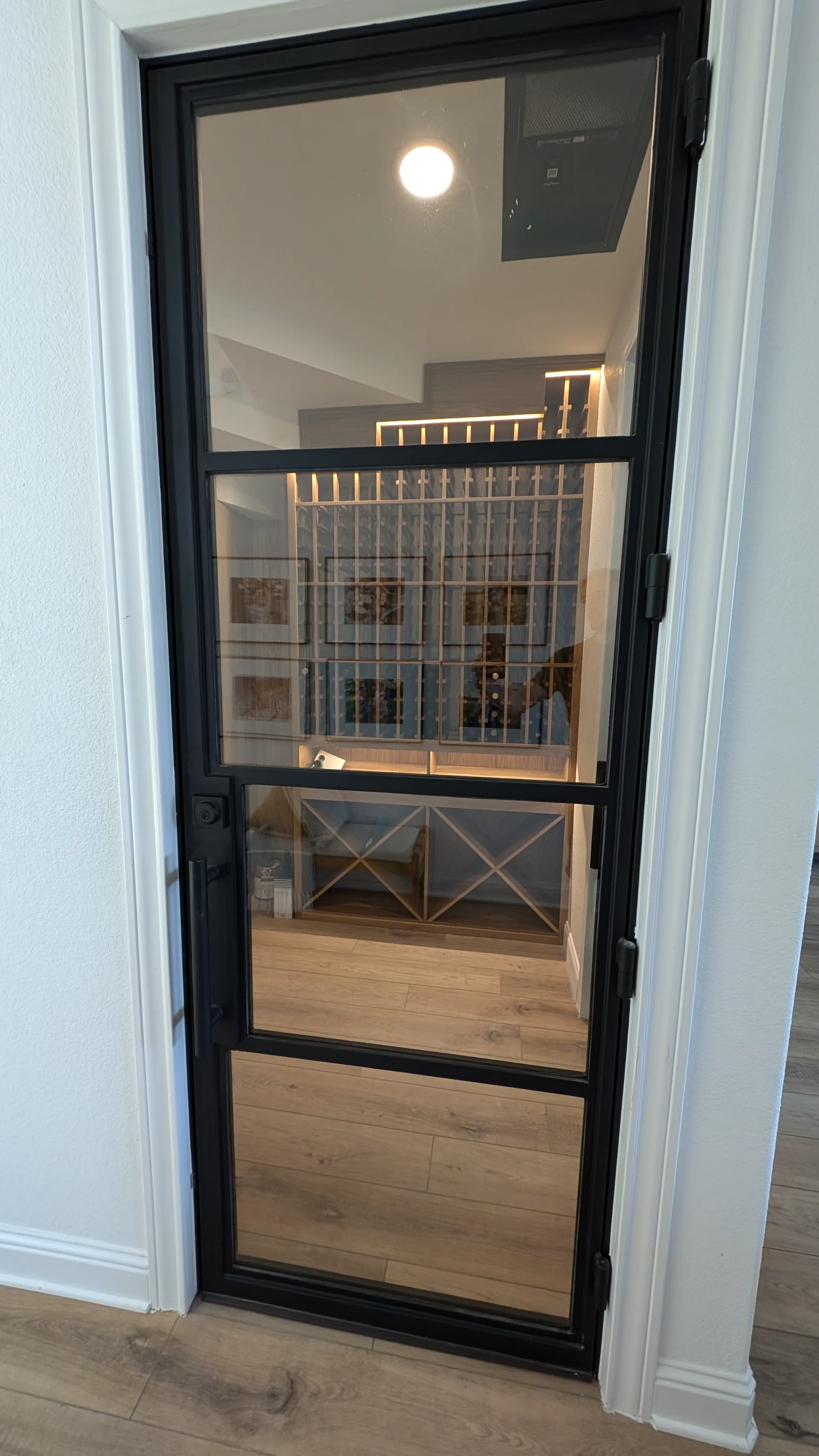 Custom-built oak wine cellar from New Project, featuring integrated LED lighting, individual bottle slots, and diamond-shaped bulk storage bins in a home located in West Lake Hills, Texas. - Detail 2