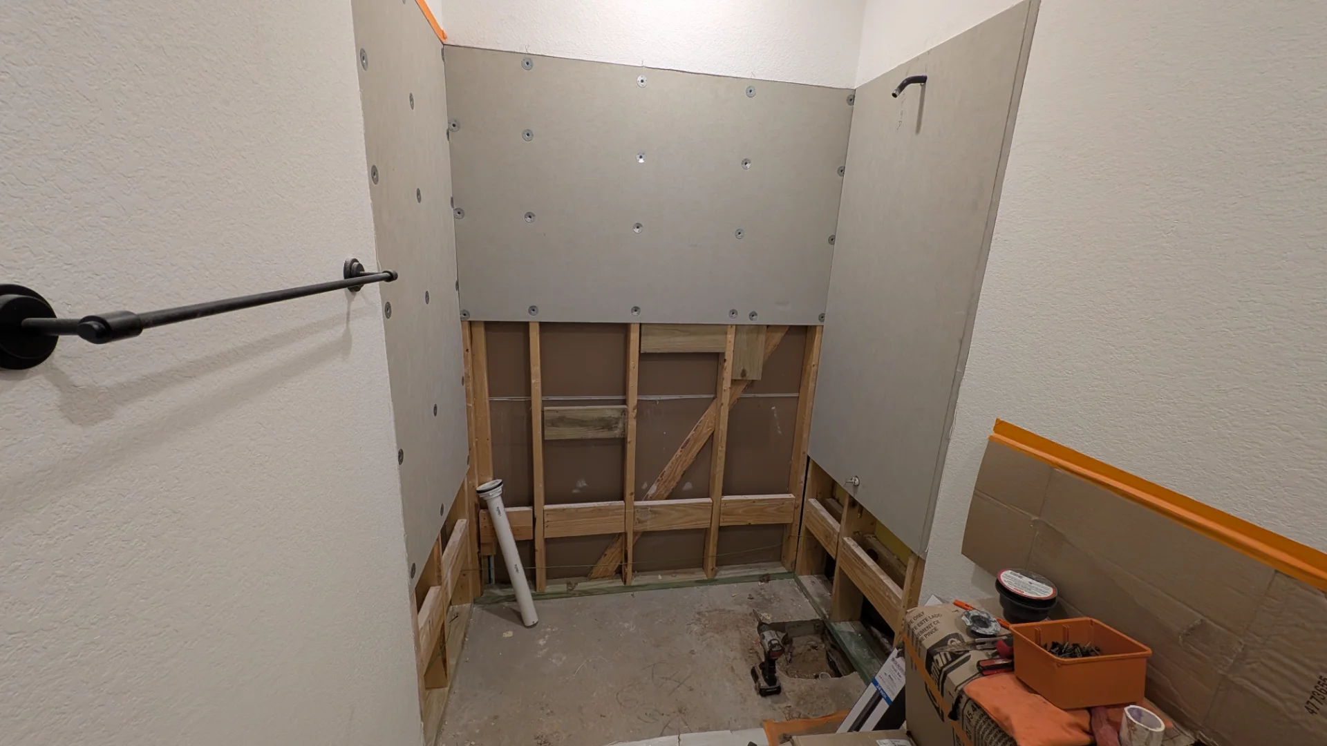 A modern walk-in shower featuring gray marble-look tile, matte black fixtures, and accessibility grab bars in a Tarrytown, Texas Hill Country home. - Detail 2